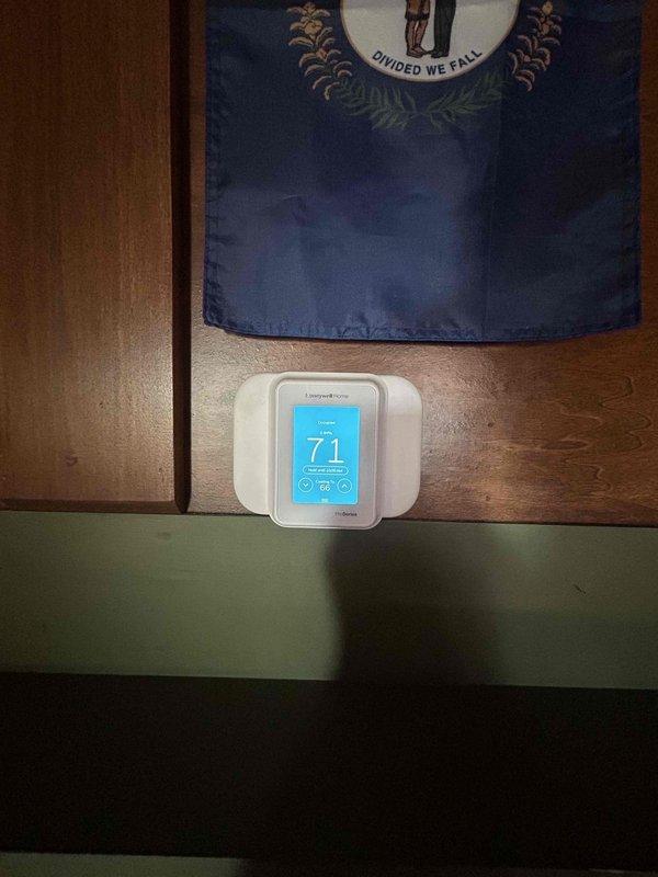 Returned to property to replace existing thermostat with new Honeywell digital touchscreen unit per customer request. Removed old thermostat, installed replacement model on wall, and programmed heating settings to customer specifications. Verified proper communication between thermostat and HVAC system, confirmed accurate temperature readings at 71 degrees, and tested heating mode operation. System responding correctly to new programming parameters.