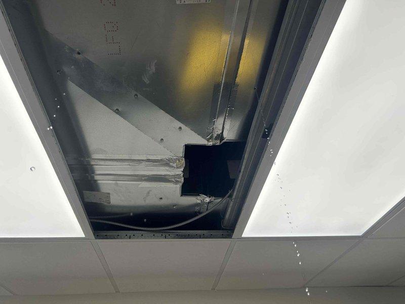 Responded to commercial water leak complaint affecting drop ceiling tiles and light fixtures. Investigated condensation issue originating from HVAC ductwork system. Inspection revealed moisture accumulation on metal ductwork with visible staining and discoloration on duct surfaces, confirming condensation as source rather than plumbing-related leak. Documented conditions of exposed ductwork above drop ceiling, including duct seams, connections, and areas where moisture had penetrated ceiling system. Assessed insulation gaps and temperature differential points contributing to condensation formation on sheet metal ductwork.