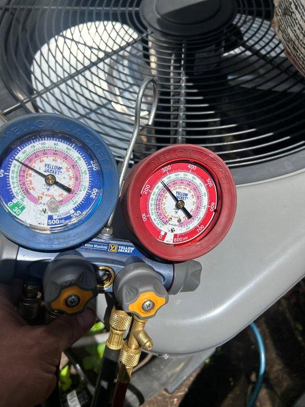 Responded to no cooling complaint on downstairs electric air conditioning unit less than 10 years old. Upon arrival, system was running but delivering warm air with thermostat set to 72°F and indoor temperature reading 77°F. Connected manifold gauge set to outdoor condensing unit and performed refrigerant pressure diagnostics on the system. Measured operating pressures on both high and low side to determine system performance and identify potential issues such as refrigerant charge levels, compressor operation, or restriction in refrigerant circuit.