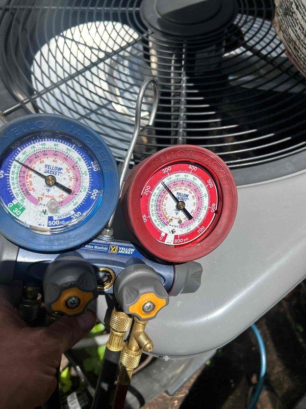 Responded to no cooling complaint on downstairs electric air conditioning unit less than 10 years old. Upon arrival, system was running but delivering warm air with thermostat set to 72°F and indoor temperature reading 77°F. Connected manifold gauge set to outdoor condensing unit and performed refrigerant pressure diagnostics on the system. Measured operating pressures on both high and low side to determine system performance and identify potential issues such as refrigerant charge levels, compressor operation, or restriction in refrigerant circuit.