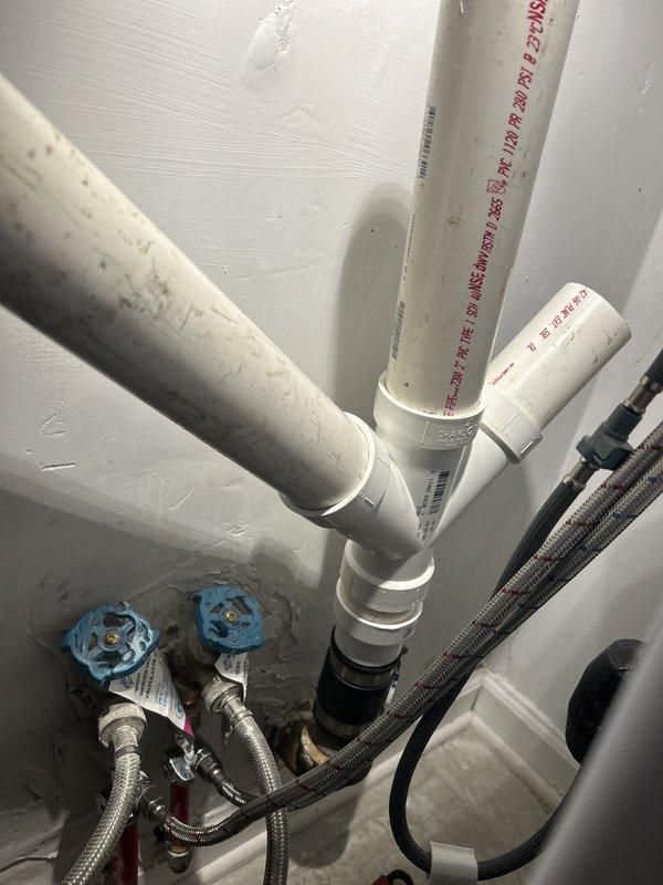 # Plumbing Service - Clogged Drain/Sink

Responded to drainage issues following recent kitchen remodel where both kitchen sinks were retaining water and washing machine exhibited leaking. Upon inspection of under-sink plumbing configuration, identified improper P-trap assembly and drainage connections installed by previous contractor. Diagnosed inadequate venting and incorrect pipe slope causing water retention in dual sink setup. Inspected garbage disposal unit connections and verified proper mounting and drain line integration. Examined water supply lines with shut-off valves and braided stainless steel flexible connectors for washing machine installation. Repositioned and reconfigured PVC drainage pipes to establish proper fall and trap seal. Verified all connections were secure and tested system operation to confirm complete drainage from both sink basins and resolved washing machine leak at supply line connection point.