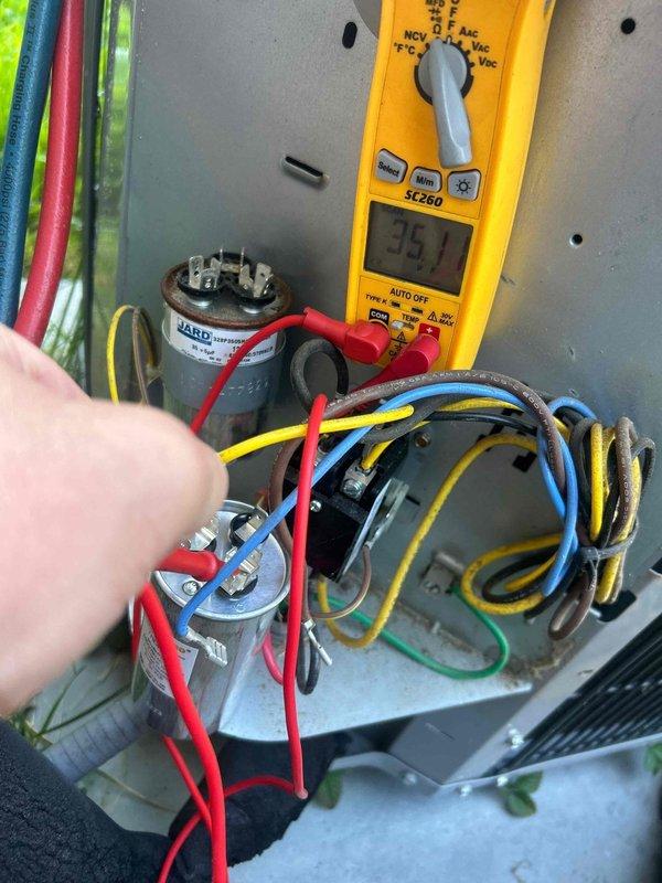 Completed preventive maintenance on 6-year-old air conditioning system. Performed comprehensive AC tune-up including system inspection, cleaning, and testing of all major components. Tested and verified capacitor operation using digital multimeter, confirming proper voltage readings of 35.7V on dual-run capacitor and hard start capacitor. Replaced two air filters at upstairs AC/gas furnace units per maintenance protocol; basement filter not replaced as homeowner supplies their own. All electrical connections inspected and found secure. System operating within normal parameters with no deficiencies noted at time of service.