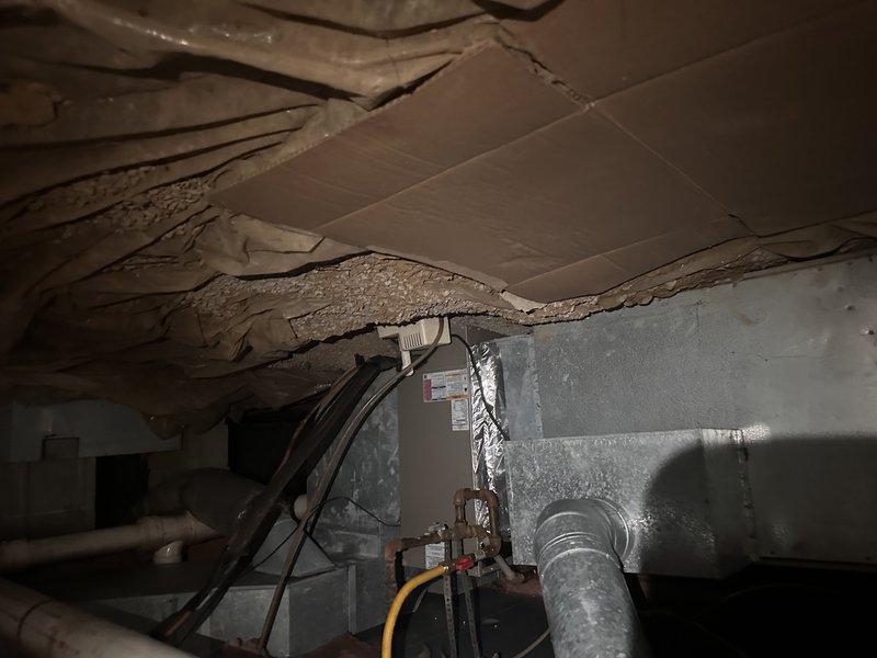 Conducted comprehensive estimate for complete furnace replacement system. Existing furnace unit is approximately 40 years old and currently operational but has exceeded its expected service life significantly. Performed thorough assessment of existing HVAC infrastructure including ductwork configuration, clearances, and installation accessibility in basement mechanical space.

Documented existing equipment dimensions and spatial constraints using precision measurements to ensure proper sizing for replacement unit. Evaluated condition of existing supply and return ductwork, noting flexible duct runs and metal trunk lines. Assessed structural conditions including deteriorated ceiling insulation showing significant sagging and compression, which may require attention during replacement installation.

Photographed existing furnace unit, ductwork connections, and surrounding mechanical space to provide accurate documentation for equipment specifications and installation planning. Measured a