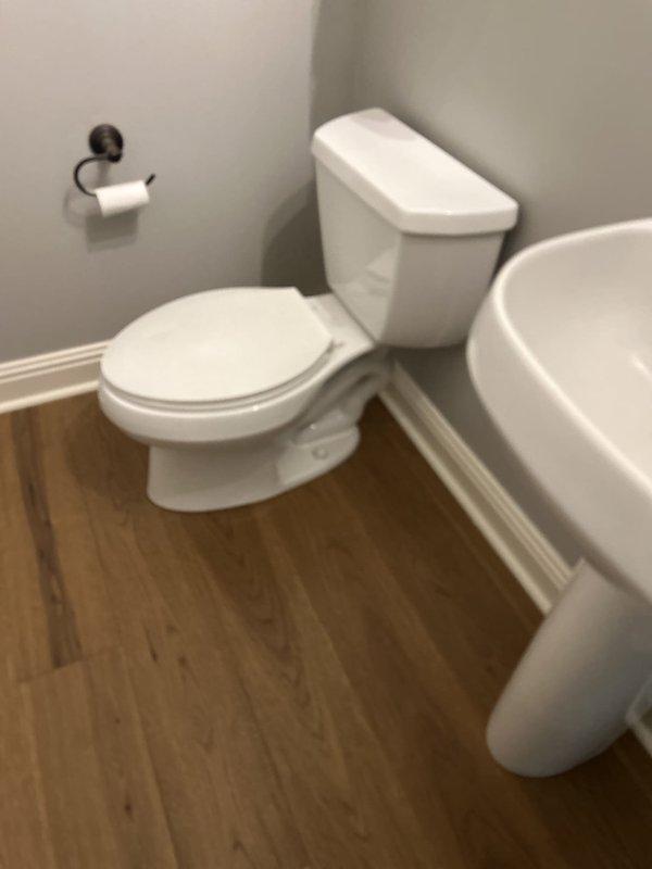 Responded to customer request to temporarily remove toilet and pedestal sink to facilitate bathroom flooring renovation. Successfully disconnected water supply line, removed toilet from corner installation, and relocated both fixtures to garage for secure storage during construction period. Return visit scheduled in 10 days to reinstall fixtures upon completion of new flooring.