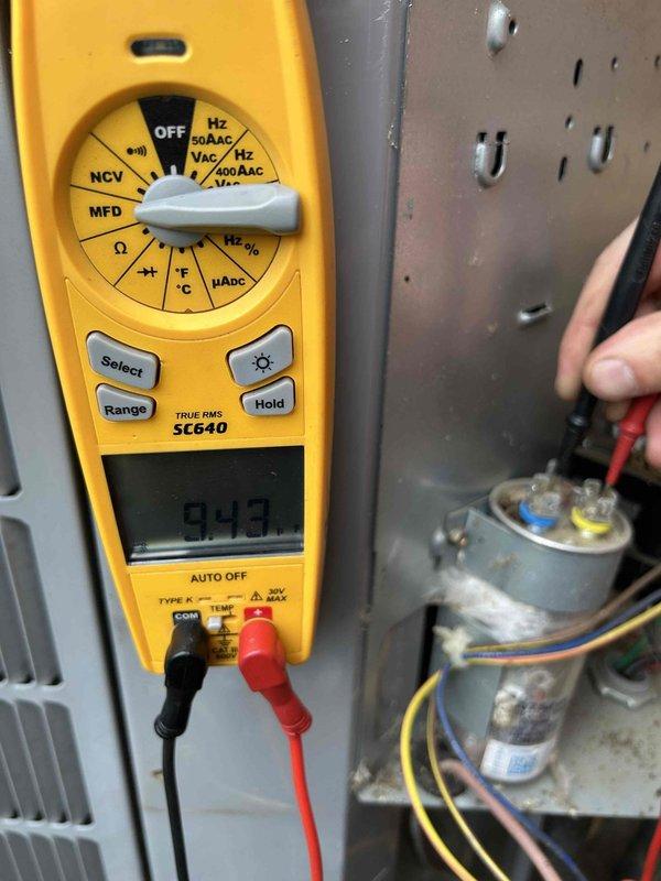 Responded to no cooling call on 6-year-old residential air conditioning system experiencing repeated circuit breaker trips. Upon arrival, performed visual inspection of outdoor condensing unit and removed access panel to examine electrical components. Using digital multimeter, tested capacitor functionality and measured microfarad readings. Initial diagnostic testing revealed capacitor reading of 0.43 MFD, indicating failed run capacitor well below manufacturer specifications. Inspected all visible wiring connections, contactor assembly, and associated electrical components for signs of damage, corrosion, or thermal stress that could contribute to overcurrent condition causing breaker trips. Documented equipment condition with photos showing interior components and diagnostic measurements for service records and repair recommendations.