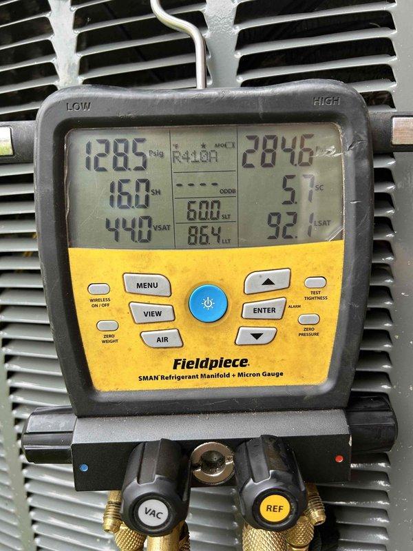 Responded to no cooling complaint on 9-year-old electric heat pump system with thermostat set to 72°F but reading 79°F and blowing warm air. Upon arrival, performed diagnostic evaluation of refrigerant system using digital manifold gauge set. Measurements revealed system operating with R410A refrigerant at 1285 psig high side pressure and 160 psig low side pressure, with subcooling reading of 51°F and superheat conditions indicating potential refrigerant charge issues. Supply air temperature measured at 95°F at ceiling register, confirming inadequate cooling performance. System showed signs of low refrigerant charge based on pressure readings and temperature differentials. Documented refrigerant pressures, temperatures, and operating conditions for further diagnosis and repair recommendations.