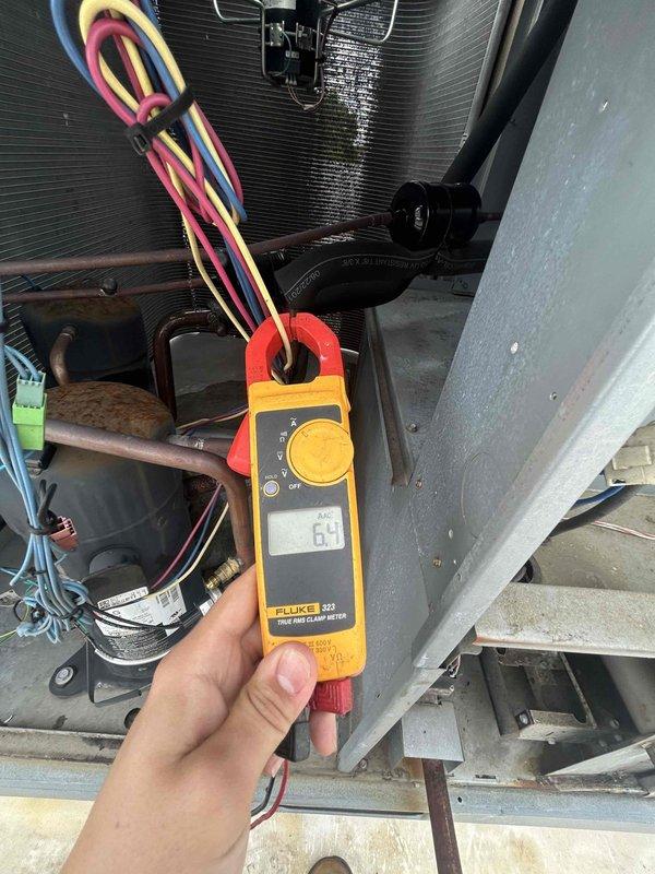 Responded to callback for HVAC system continuously tripping breaker following previous day's service visit. Upon arrival, confirmed breaker had been left in off position by customer after repeated trips. Performed electrical diagnostics on outdoor condensing unit using clamp meter and multimeter to measure amperage draw and voltage at compressor and associated components. Readings indicated compressor drawing 6.5 amps during testing. Inspected all electrical connections, wiring, capacitor, and contactor for signs of short circuit or ground fault that could cause breaker to trip. Documented findings with photos showing electrical measurements and system components for further analysis and warranty documentation purposes.