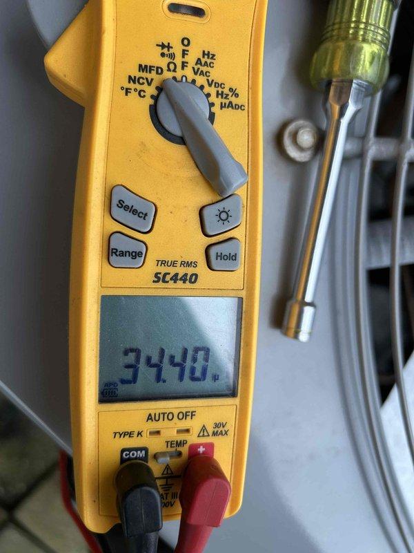 Completed Gold Level prepaid maintenance on single heat pump/air handler system located in crawlspace. Performed comprehensive system inspection including electrical measurements using clamp meter, verified capacitor readings at 3448 microfarads, and inspected condensate drain assembly with trap and safety switch. Confirmed all components operating within normal parameters and documented system condition with photos for service records.