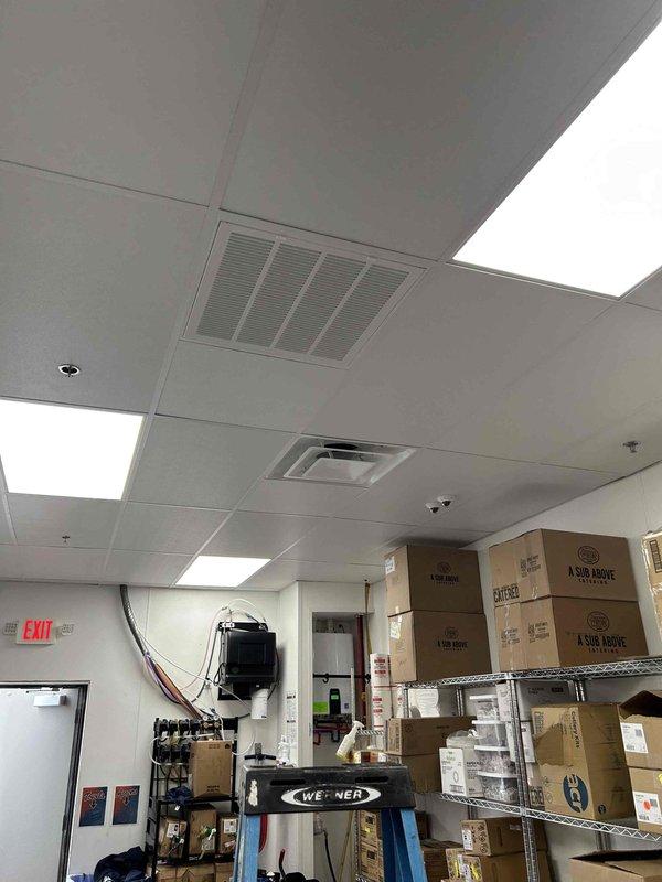 Completed HVAC Install Warranty inspection in commercial kitchen facility. Documented installation of ceiling-mounted ventilation grilles and HVAC diffusers in acoustic tile ceiling system, verified proper placement of smoke detection devices, and photographed electrical connections and control panel installations to confirm warranty compliance.