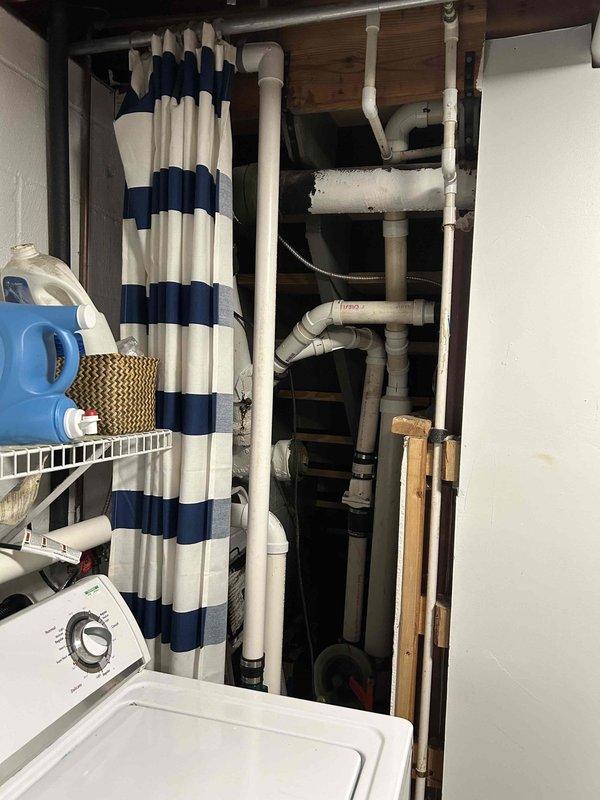 Installed a bucket pump system to handle laundry discharge in the utility area. Rerouted the existing sump pump discharge line to exit the building independently, with the discharge point positioned over the driveway. All plumbing connections completed with PVC piping, ensuring proper drainage flow and system functionality.