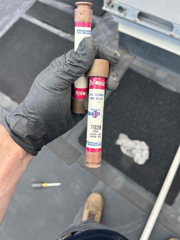 Responded to no cooling call on commercial HVAC system with no thermostat communication. Upon inspection, discovered blown dual element time delay fuses (TRS250, 250A/300V AC rating) in electrical disconnect serving the outdoor condensing unit. Inspected Copeland scroll compressor (Model ZR57KC_TFD-130, Serial 05BD31920) and verified all electrical connections and wiring at compressor terminals were intact. Replaced failed fuses and restored power to unit. System successfully powered on, established thermostat communication, and began normal cooling operation. Verified proper compressor startup and confirmed unit returned to normal functionality.