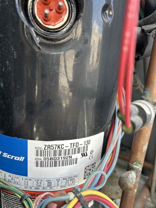 Responded to no cooling call on commercial HVAC system with no thermostat communication. Upon inspection, discovered blown dual element time delay fuses (TRS250, 250A/300V AC rating) in electrical disconnect serving the outdoor condensing unit. Inspected Copeland scroll compressor (Model ZR57KC_TFD-130, Serial 05BD31920) and verified all electrical connections and wiring at compressor terminals were intact. Replaced failed fuses and restored power to unit. System successfully powered on, established thermostat communication, and began normal cooling operation. Verified proper compressor startup and confirmed unit returned to normal functionality.