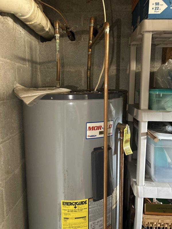 Responded to no hot water complaint on 10-year-old Mor-Flo tank water heater connected to geothermal system. Upon inspection, diagnosed failed heating element and thermostat malfunction preventing proper water heating while geothermal cooling system continued normal operation. Replaced defective upper heating element, installed new thermostats, flushed sediment buildup from tank, and verified all plumbing connections and pressure relief valve for proper operation. Restored hot water supply to full functionality and confirmed system returned to normal operating temperature.