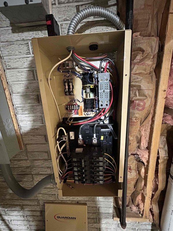 Responded to service call for Generac Guardian generator (Serial #4041830) experiencing transfer switch malfunction and oil leak. System successfully transferred to generator power during outage but failed to return to utility power, indicating automatic transfer switch issue. Inspected transfer switch panel and internal contactors, documented electrical connections and relay components. Identified active oil leak requiring attention and noted unit maintenance status evaluation needed. Photographed transfer switch assembly and generator components for diagnostic purposes.