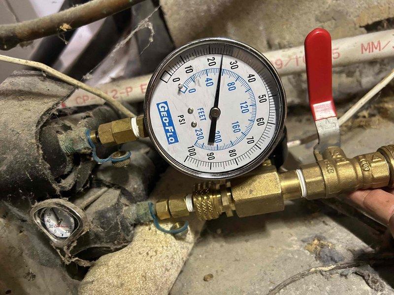 Installed new drain line for upstairs HVAC unit and safety switch to prevent overflow damage. Inspected and tightened seals on geothermal flow center to address active leak issue, monitoring to determine if component replacement will be necessary. Verified system pressures using calibrated gauge and confirmed both geothermal units had been previously flushed per maintenance records.
