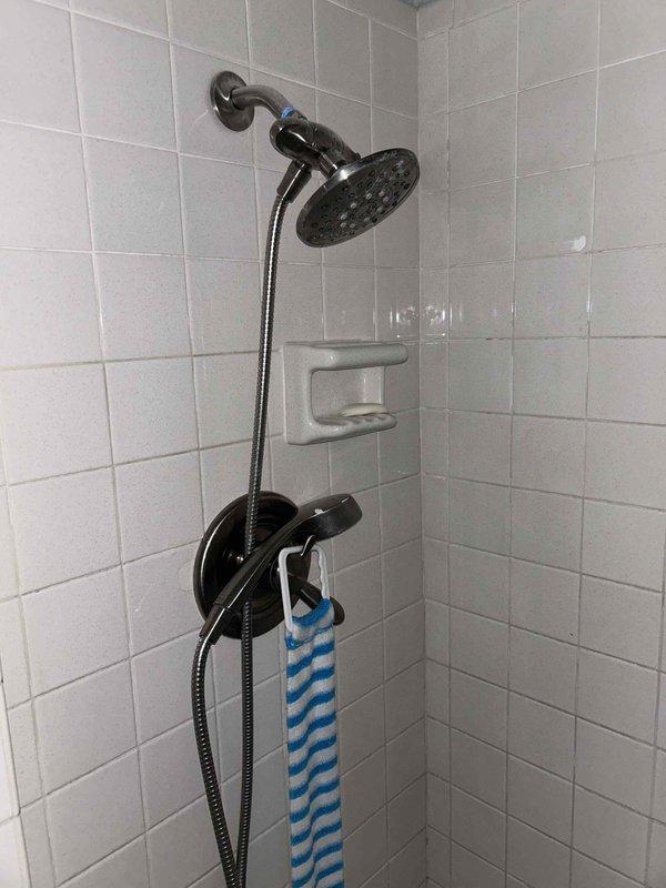 Completed recurring plumbing preventive service agreement inspection of residential bathroom fixtures and water heater system. Evaluated water heater condition to determine if tank flushing maintenance could be safely performed and provided estimate for recommended service. Documented existing plumbing fixtures including dual shower systems, tub assemblies, and chrome hardware in working condition.