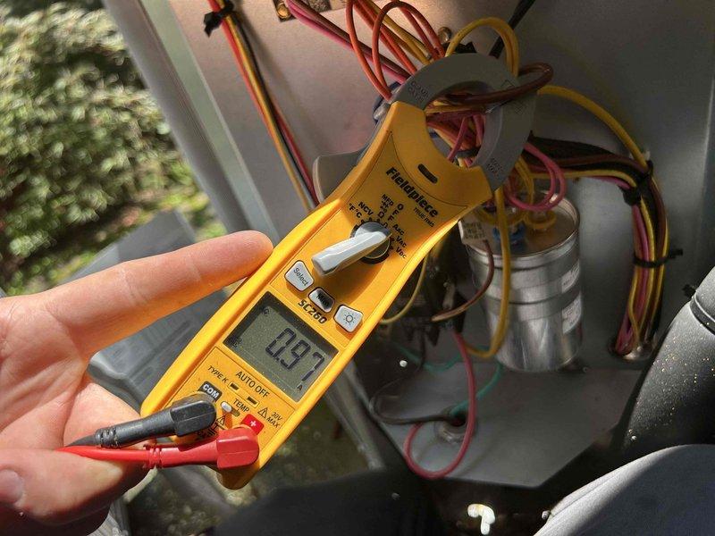 Completed comprehensive Care Plan tune-up on dual heat pump and air handler systems located in attic and basement as part of complimentary first-year maintenance program included with two-system installation. Performed electrical diagnostics using multimeter to verify proper voltage readings at capacitor terminals, confirming system operating at 139.5 volts within acceptable parameters. Inspected and tested all electrical connections, capacitor functionality, and wiring integrity on both HVAC units. Replaced 16x20x1 air filters in both attic and basement systems to ensure optimal airflow and system efficiency. Verified thermostat operation showing indoor temperature at 69°F with outdoor reading of 82°F, confirmed unit responding properly to programmed schedule settings and maintaining desired setpoint.