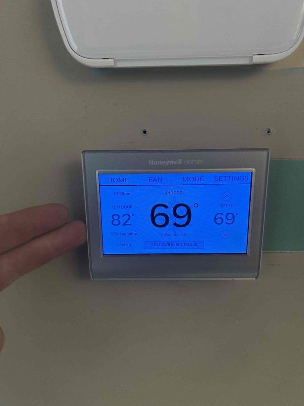 Completed comprehensive Care Plan tune-up on dual heat pump and air handler systems located in attic and basement as part of complimentary first-year maintenance program included with two-system installation. Performed electrical diagnostics using multimeter to verify proper voltage readings at capacitor terminals, confirming system operating at 139.5 volts within acceptable parameters. Inspected and tested all electrical connections, capacitor functionality, and wiring integrity on both HVAC units. Replaced 16x20x1 air filters in both attic and basement systems to ensure optimal airflow and system efficiency. Verified thermostat operation showing indoor temperature at 69°F with outdoor reading of 82°F, confirmed unit responding properly to programmed schedule settings and maintaining desired setpoint.