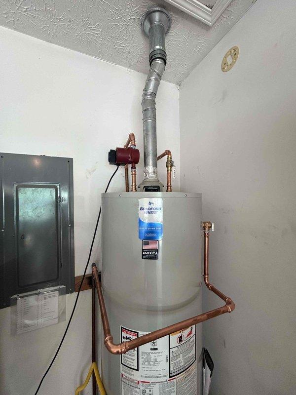 Removed and disposed of failed 50-gallon A.O. Smith gas water heater experiencing active leakage. Installed new Bradford White 50-gallon residential gas water heater on existing platform in utility closet. Connected copper supply lines to hot and cold water ports at top of unit and attached metallic vent pipe for proper exhaust ventilation. Installed recirculation pump on hot water line to provide continuous hot water circulation throughout residence. Connected gas supply line to control valve at base of unit and verified all connections for leaks using approved testing methods. Tested temperature and pressure relief valve for proper operation. Energized unit and verified ignition sequence, burner operation, and proper venting. Confirmed adequate combustion air supply and clearances meet manufacturer specifications. Allowed unit to reach operating temperature and inspected all plumbing connections under pressure for leaks. Verified proper functionality of all components prior to depart
