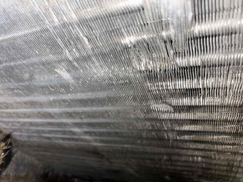 Responded to no airflow complaint on 7-year-old electric heat pump system. Upon arrival, performed diagnostic inspection of indoor air handler unit. Found blower motor had failed, preventing air circulation through the system. Observed significant dust and debris accumulation on evaporator coil and throughout air handler cabinet, indicating extended period without filter maintenance. Inspected flexible ductwork and found deteriorated insulation and surface staining consistent with age and lack of maintenance. Replaced failed blower motor and capacitor. Cleaned evaporator coil and cabinet interior. Verified proper airflow restoration and system operation. Advised ongoing filter maintenance requirements to prevent future issues.