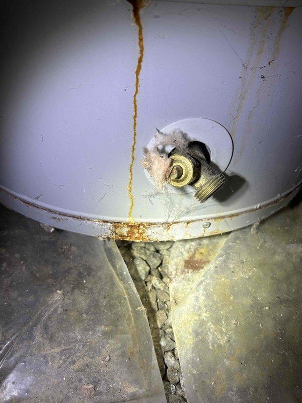 # HVAC Visual Inspection - AC and Furnace System

Performed comprehensive visual inspection of residential HVAC system including approximately 17-year-old air conditioning unit and furnace per customer request. Indoor air handler located in crawlspace.

## Findings

**Evaporator Coil:** Inspected indoor coil assembly and discovered heavy dust and debris accumulation on coil fins, significantly restricting airflow. Observed extensive ice formation and frost buildup on upper plenum surfaces, indicating restricted airflow and potential refrigerant issues. Coil fins heavily soiled with grayish-black contamination throughout.

**System Performance Issues:** Ice accumulation on coil components suggests system is operating under conditions causing abnormal moisture freezing, likely due to combination of reduced airflow from dirty coils and possible low refrigerant charge. This condition will severely impact cooling efficiency and system capacity.

**Water Heater (Incidental Observation):** No