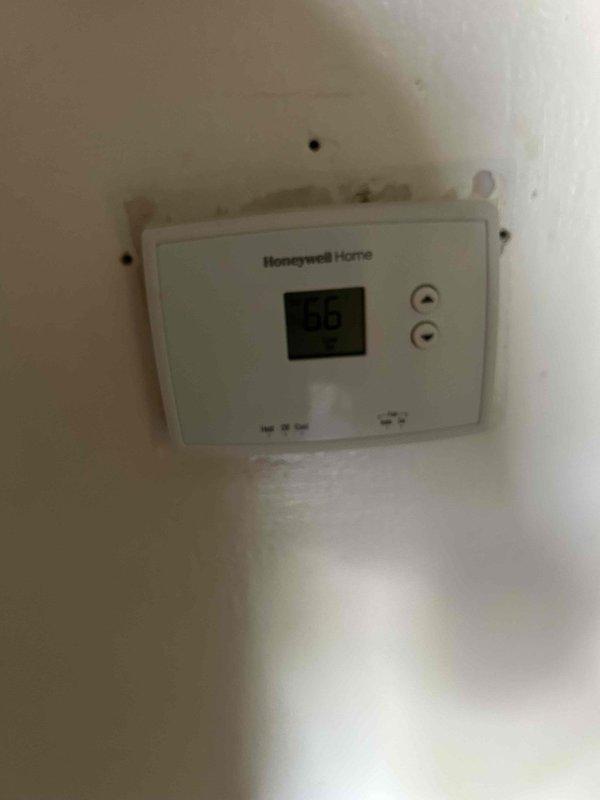 Responded to no-cool call on 40+ year old residential air conditioning system with outdoor condenser unit not running and indoor unit blowing warm air. Performed diagnostic inspection of outdoor condenser unit and indoor air handler located in basement. Assessed system condition, checked electrical connections at disconnect box, and evaluated thermostat operation showing 90-degree indoor temperature reading on Honeywell Home unit.