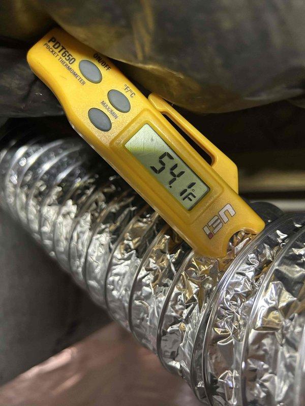 Responded to callback for newly installed HVAC system with inadequate airflow and no cooling. Upon inspection, discovered severely compressed and kinked flexible ductwork restricting airflow to supply registers. Measured supply air temperature at 33.1°F and return air at 57°F, confirming refrigeration system operating properly but airflow obstruction preventing adequate distribution. Repositioned and straightened flexible aluminum duct runs to restore proper airflow, eliminating restrictions that were preventing conditioned air from reaching living spaces. System now delivering adequate airflow and cooling performance as designed.