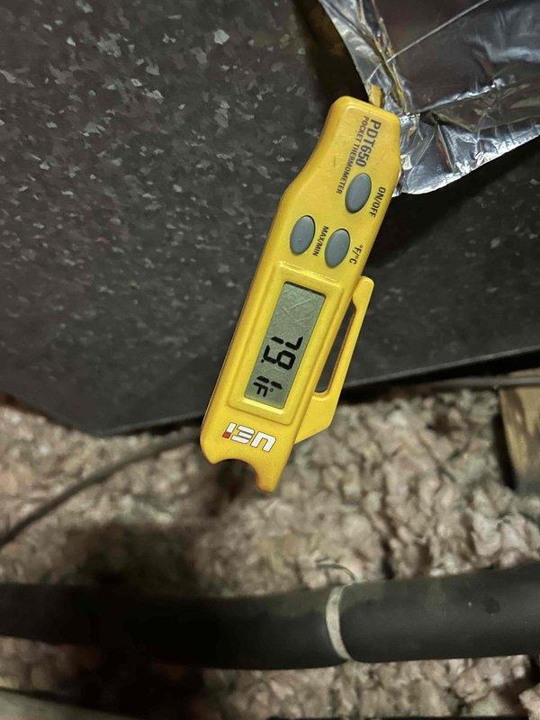 Responded to no cooling call on 10-year-old electric air conditioning system with indoor unit located in attic. Upon arrival, confirmed outdoor condensing unit was not energizing and system was blowing warm air through supply vents. Performed diagnostic testing and measured supply air temperature at 79°F, indicating lack of refrigeration cycle operation. Inspected Honeywell Home ProSeries thermostat, which was calling for cooling and set to auto fan mode at 76°F setpoint. Troubleshot electrical circuit from thermostat through control wiring to outdoor unit to identify failure point preventing compressor and condenser fan operation.