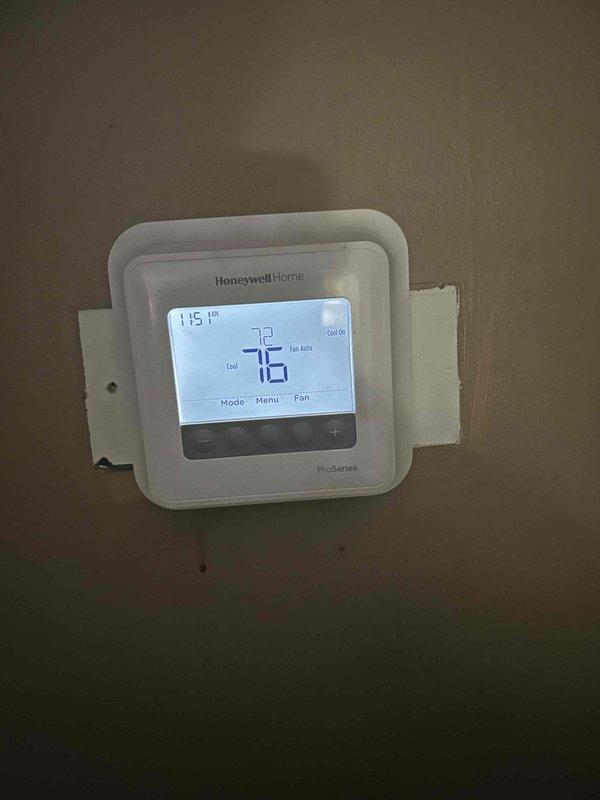 Responded to no cooling call on 10-year-old electric air conditioning system with indoor unit located in attic. Upon arrival, confirmed outdoor condensing unit was not energizing and system was blowing warm air through supply vents. Performed diagnostic testing and measured supply air temperature at 79°F, indicating lack of refrigeration cycle operation. Inspected Honeywell Home ProSeries thermostat, which was calling for cooling and set to auto fan mode at 76°F setpoint. Troubleshot electrical circuit from thermostat through control wiring to outdoor unit to identify failure point preventing compressor and condenser fan operation.