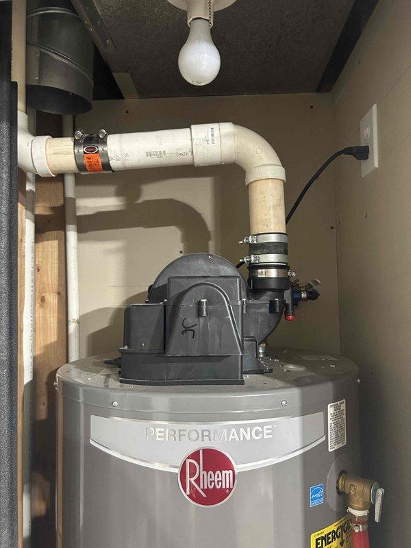 # Water Heater Gas Ignition Repair

Responded to service call for Rheem Performance tanked water heater with reported gas odor and ignition failure. Gas utility company had previously identified the water heater as the source and confirmed flame would not light. Upon inspection, diagnosed faulty ignition system preventing burner from lighting properly.

Performed complete diagnostic evaluation of gas control valve, thermocouple, and ignition assembly. Identified malfunctioning pilot assembly causing ignition failure and gas odor concern. Replaced defective pilot assembly and tested all safety controls to ensure proper operation. Verified gas connections for leaks using approved leak detection solution. Confirmed proper combustion air supply to power vent system and inspected PVC exhaust venting for obstructions or damage.

Cycled unit through multiple heating cycles to verify reliable ignition and proper burner operation. Tested temperature and pressure relief valve for proper function