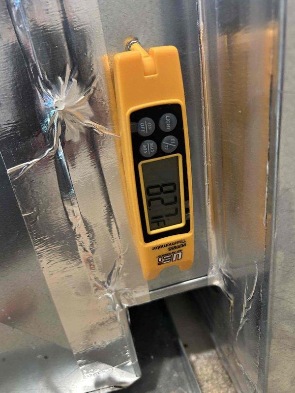 Responded to no cooling complaint on heat pump system. Upon arrival, performed diagnostic evaluation of indoor air handler unit located in closet. Measured supply air temperature at ductwork registering 133°F, indicating system operating in heat mode rather than cooling mode. Inspected outdoor heat pump unit and verified manufacturer specifications on equipment nameplate. Identified thermostat wiring or reversing valve issue preventing proper mode changeover from heating to cooling operation. System requires correction of control circuit or reversing valve to restore proper cooling function.