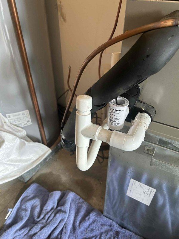 Responded to call back for 7-year-old heat pump system with no cooling and intermittent thermostat power loss following previous service on 7/29. Found condensate drainage issue causing safety float switch activation, resulting in system shutdown and thermostat display going blank. Cleared condensate line blockage, verified proper drainage through P-trap assembly, and tested condensate pump operation. Confirmed 24V power supply to thermostat restored and stable. Cycled system through complete cooling operation, verified proper airflow from air handler, and confirmed indoor temperature pulldown. System operating normally with no further power interruptions to thermostat.