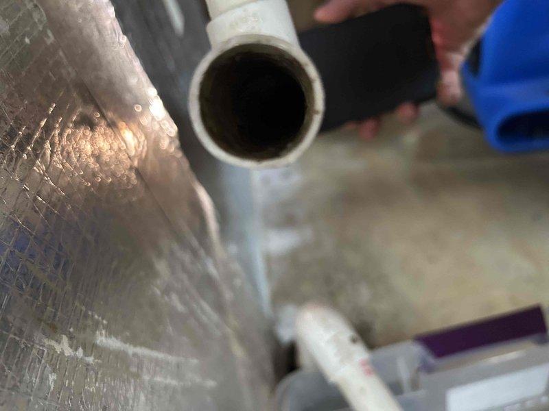 Responded to water leak at basement indoor unit with standing water inside equipment causing wall damage. Found condensate drain line completely clogged, preventing proper drainage and resulting in water accumulation within the system. Cleared blockage from condensate line and verified proper drainage flow to prevent further water damage to equipment and surrounding structure.