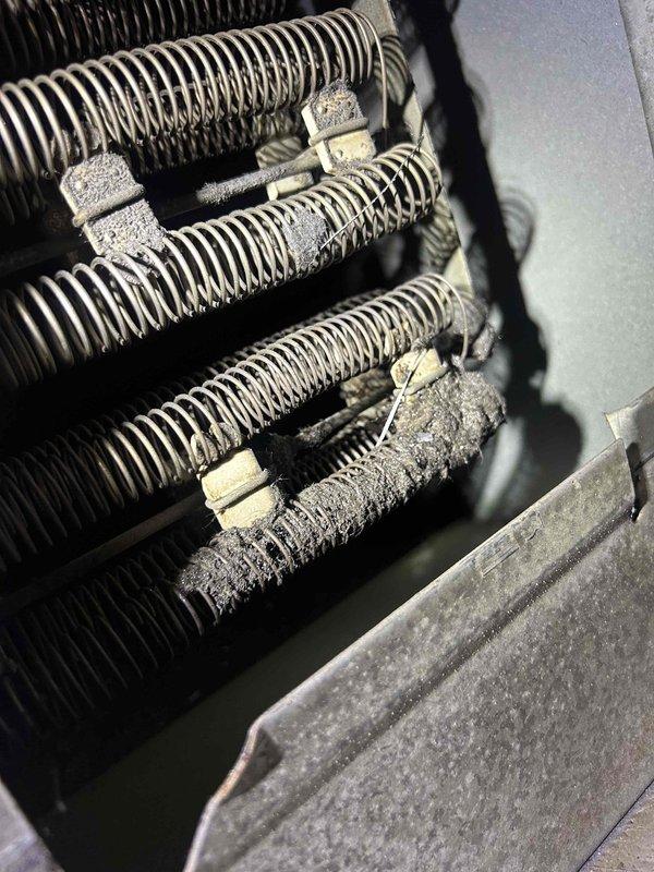 Responded to no cooling complaint on air handler/heat pump system with reported humming noise at outdoor unit. Upon inspection, found failed dual run capacitor preventing compressor from starting, confirming previous maintenance observation of capacitor deterioration. Replaced defective capacitor with manufacturer-specified replacement and verified proper compressor amperage draw and system operation. Additionally noted significant dust and lint accumulation on evaporator coil restricting airflow, which was documented for future maintenance scheduling. Tested system through complete cooling cycle, confirmed proper refrigerant pressures, verified adequate airflow at registers, and restored normal cooling operation. System operating within manufacturer specifications at time of departure.