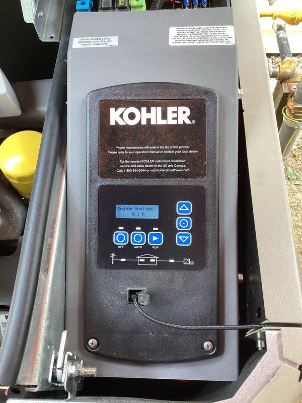 Performed initial startup and commissioning on newly installed Kohler generator system. Verified control panel functionality, confirmed engine runtime registration at 0.2 hours, tested OFF/AUTO/RUN selector positions, and inspected circuit breaker connections to ensure proper electrical integration with the building's power distribution system.