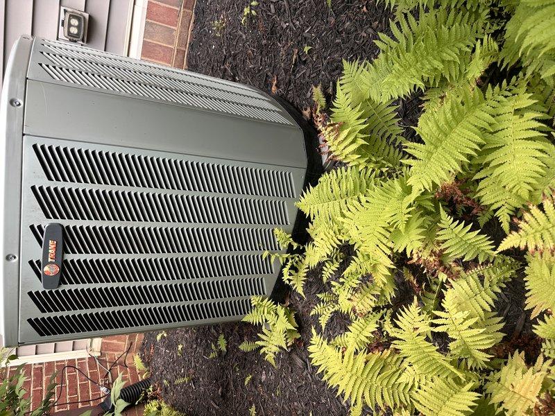 Responded to no-cool condition on heat pump system less than 10 years old with reported humming noise and suspected capacitor failure. Evaluated outdoor heat pump unit and attic-mounted air handler, documenting existing equipment condition and installation environment. Provided comprehensive replacement estimate for complete heat pump/air handler system and water heater as requested, with temporary window unit supplied for interim cooling needs.