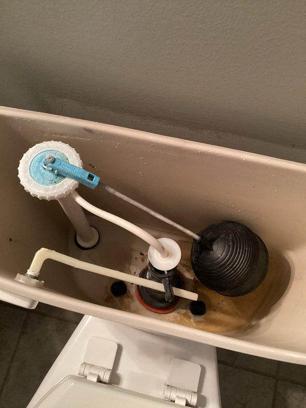 Responded to a continuously running toilet in a 13-year-old residential property. Upon inspection, removed the tank lid and identified a deteriorated flapper valve that was no longer sealing properly against the flush valve seat, allowing water to leak from the tank into the bowl. Replaced the worn black rubber flapper with a new unit and adjusted the fill valve to ensure proper water level. Tested the flush mechanism multiple times to confirm the toilet now fills and shuts off correctly without continuous running. System is operating within normal parameters.