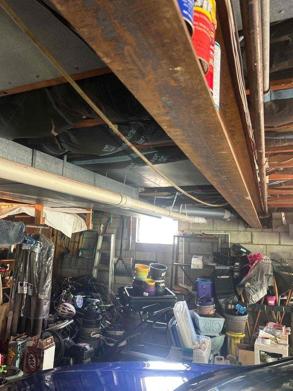 Responded to no cooling complaint on 10+ year old central air conditioning system affecting entire residence. Upon arrival, performed comprehensive system inspection of both indoor and outdoor units. Observed heavy condensation on refrigerant lines at outdoor unit, indicating active refrigerant flow but potential system inefficiency. Inspected indoor evaporator coil assembly located in basement mechanical area. Checked electrical connections, capacitor operation, and contactor functionality. Measured temperature differential across evaporator coil and verified blower motor operation. Assessed refrigerant charge levels and system pressures. Cleaned condensate drain line to ensure proper drainage. Tested thermostat communication and calibration. System restored to proper cooling operation with appropriate temperature split achieved across indoor coil. Advised customer of system age and recommended monitoring performance, as units over 10 years may require more frequent maintenance or fut