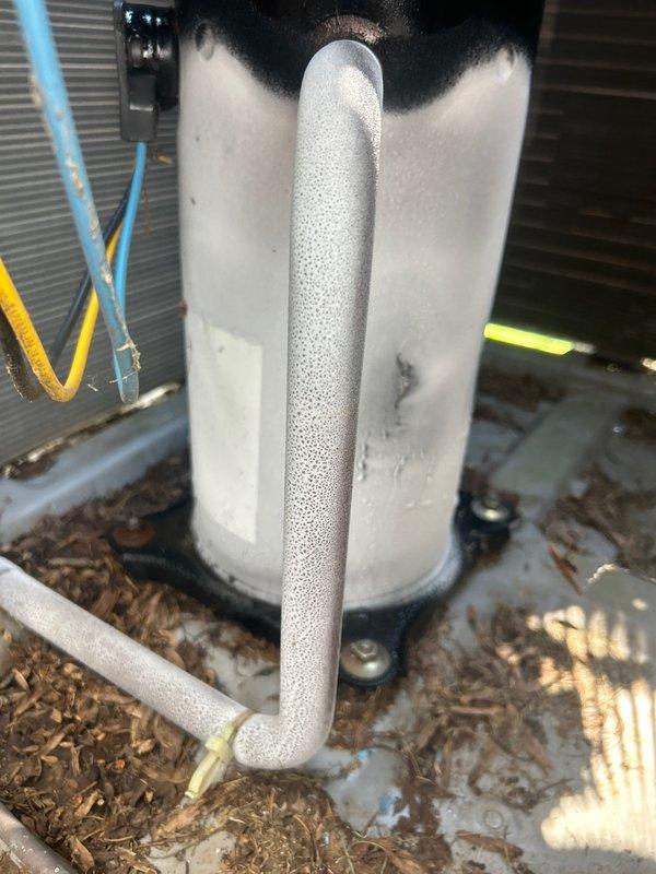 Responded to no cooling complaint on 10+ year old central air conditioning system affecting entire residence. Upon arrival, performed comprehensive system inspection of both indoor and outdoor units. Observed heavy condensation on refrigerant lines at outdoor unit, indicating active refrigerant flow but potential system inefficiency. Inspected indoor evaporator coil assembly located in basement mechanical area. Checked electrical connections, capacitor operation, and contactor functionality. Measured temperature differential across evaporator coil and verified blower motor operation. Assessed refrigerant charge levels and system pressures. Cleaned condensate drain line to ensure proper drainage. Tested thermostat communication and calibration. System restored to proper cooling operation with appropriate temperature split achieved across indoor coil. Advised customer of system age and recommended monitoring performance, as units over 10 years may require more frequent maintenance or fut