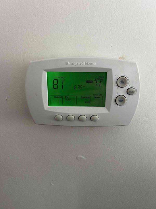 # No Cooling Complaint - System Restored to Operation

Responded to no cooling complaint for residential air conditioning system. Upon arrival, verified thermostat was calling for cooling with indoor temperature at 81°F and setpoint at 77°F. Thermostat display and controls functioning properly with Honeywell Home digital unit showing normal operation.

Proceeded to crawl space to inspect outdoor condensing unit and air handler. Located HVAC equipment in below-grade installation with concrete block foundation surroundings. Visually inspected air handler unit with connected PVC condensate drainage lines and main supply ductwork. 

Performed diagnostic testing on system components to identify cause of no cooling condition. Checked electrical connections, refrigerant pressures, and airflow at equipment. Identified failed component preventing system operation. Completed necessary repairs to restore cooling function.

Verified proper system operation with unit running through complete coolin