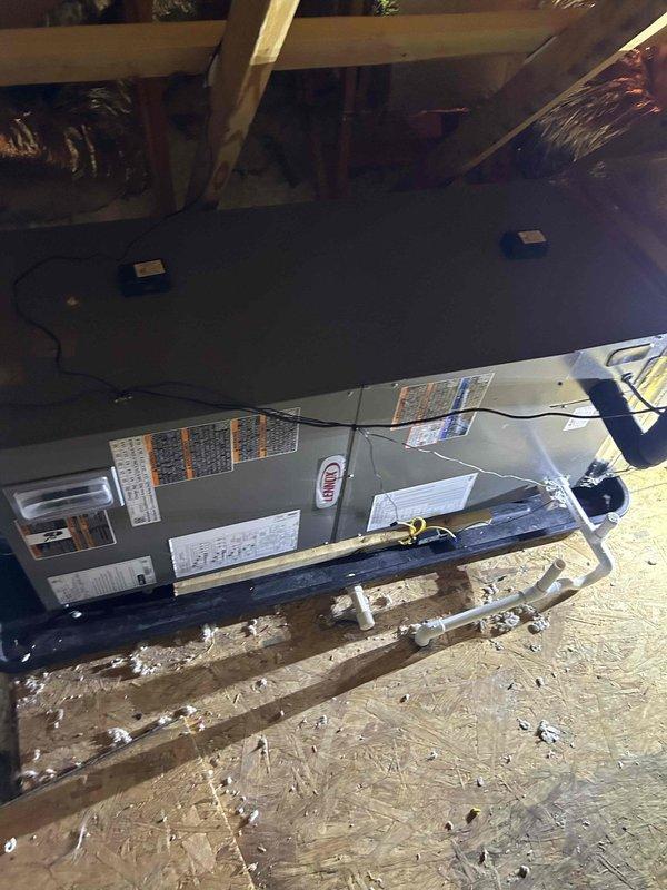 Completed full residential HVAC system replacement in attic space, installing Lennox 3-ton single stage heat pump (ML14KP1-036) with variable speed air handler (CBK45UHVT-036-230-71E) and electric heater kit (CB45-15CB-P). Removed and disposed of existing equipment per code compliance requirements.

Installed outdoor heat pump unit on concrete pad with snow legs for elevation and protection. Connected electrical whip kit to new disconnect box at outdoor unit location. Ran and insulated refrigerant lines between outdoor condenser and indoor air handler, installing refrigerant line filter for system protection.

Mounted variable speed air handler horizontally on platform in attic space, securing unit to structural framing. Fabricated transitions to connect new equipment to existing ductwork system. Installed standard-sized air filter rack for proper filtration and maintenance access.

Completed all condensate drainage components including trap installation, SS2 coil drain safety water se