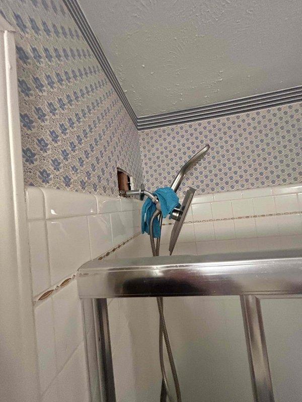 Responded to a referral service call for multiple plumbing issues throughout the residence. Assessed outdoor spigot positioned too low for proper tee junction connection and evaluated relocation requirements. Investigated downstairs bathroom sink with drainage obstruction and potential leak beneath fixture. Inspected master bathroom upstairs where previous contractor's tub installation resulted in faulty drain assembly that fails to retain water, requiring replacement of drain mechanism. Documented conditions with photographs showing bathroom fixtures, tile work, and plumbing connections. Provided evaluation for additional drain repair work needed in upstairs hallway bathroom and prepared estimate for complete bathroom remodel including tub installation and associated plumbing modifications.