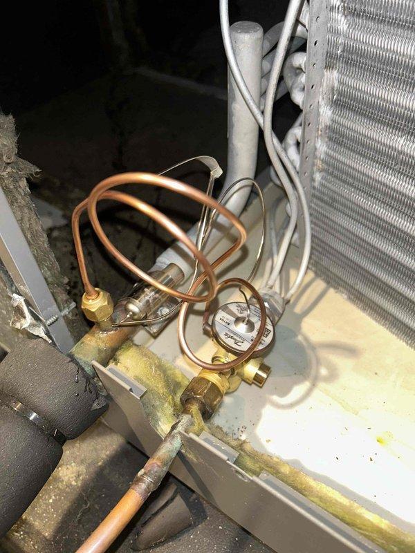 Responded to service call for Lennox HVAC system requiring warranty TXV (thermostatic expansion valve) replacement. Replaced defective expansion valve with warranty part, successfully reusing existing refrigerant charge to minimize system downtime. Completed installation and verified proper system operation with temperature readings confirming 55°F supply air temperature, indicating correct refrigerant flow and system performance.