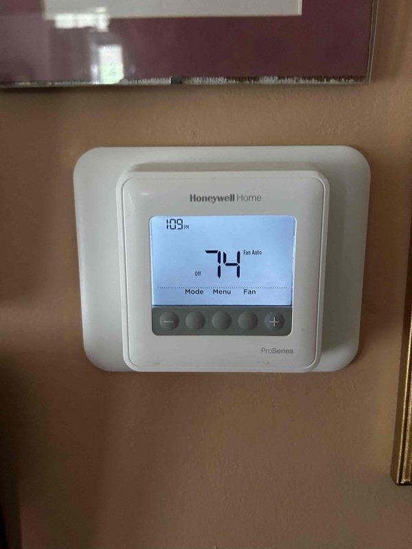 Responded to no cooling complaint on 2-year-old electric AC system reporting warm air discharge and unusual noise. Upon arrival, verified thermostat set to cooling mode at 74°F. Performed diagnostic inspection of Bryant furnace/air handler and outdoor condensing unit. Identified abnormal operational sounds requiring further investigation of blower motor assembly and compressor function. Documented system configuration and current operating conditions with photographic evidence for service records.