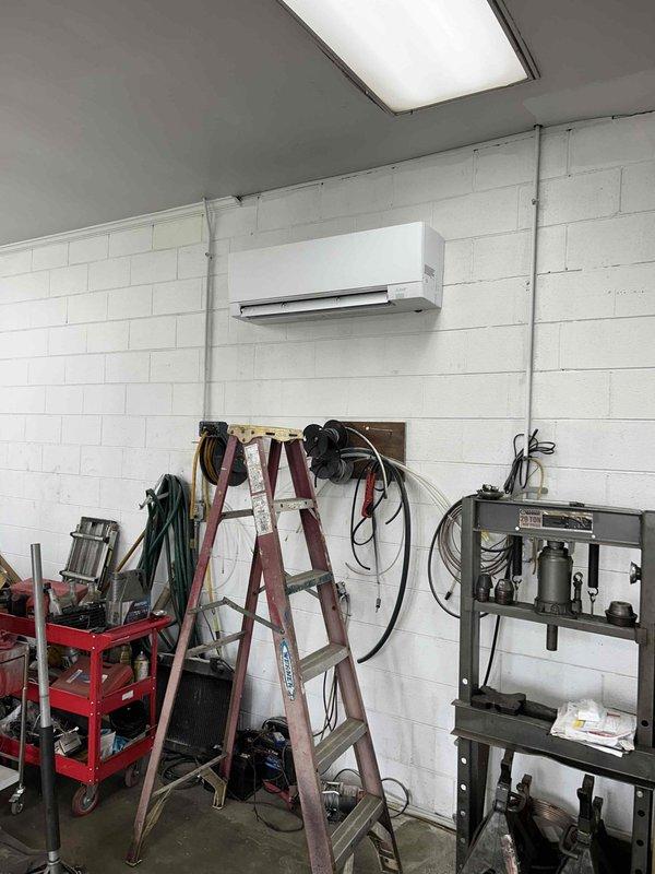 Responded to callback for mini-split system installed on 7/10 with inadequate cooling in shop area while office head unit operating normally. Arrived on site and performed diagnostic evaluation of the underperforming shop head unit, which was running continuously but maintaining only 83°F ambient temperature. Conducted visual inspection of indoor head unit mounted in shop space and traced refrigerant lines to outdoor condensing unit. Documented system conditions with photos showing installation configuration and equipment layout. Refrigerant charge had been previously reclaimed and corrected to manufacturer specifications by another technician days prior. Contacted technical support to authorize any necessary parts ordering before proceeding with repairs. System requires further troubleshooting to identify root cause of insufficient cooling capacity in shop zone.