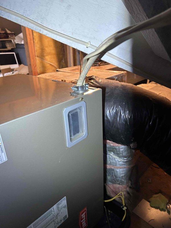 Completed full residential HVAC system replacement including Bryant 5-ton 16 SEER2 Legacy heat pump (model 235SAN06000A), Bryant 5-ton air handler (model FJ5ANXD60L00), and Bryant 15kW heat kit (model TU-EC-15BKB). Removed and disposed of existing equipment per code requirements. Installed outdoor heat pump unit on existing pad with snow legs, electrical whip kit, disconnect box, insulated refrigerant lines, and refrigerant line filter. Mounted air handler in attic space with auxiliary drain pan equipped with safety switch, SS2 coil drain safety water sensor, and "Ceiling Saver" overflow drain pan with water sensor. Installed trap and transitioned to existing ductwork with standard-sized air filter rack. Integrated system with existing thermostat. Completed all electrical connections, refrigerant line installation with proper insulation, and verified system operation. Obtained applicable permits and ensured all work met code compliance standards.