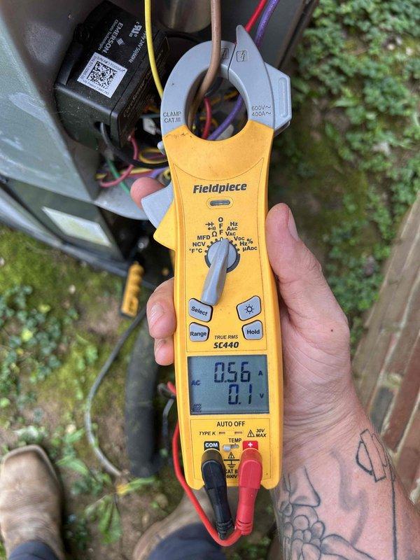 Responded to a second opinion request for a gas furnace/air conditioning system with no cooling issue. Performed diagnostic testing using clamp meter showing low amperage reading of 0.56A at outdoor unit, indicating potential compressor or electrical failure. Measured supply air temperature at 54°F at insulated ductwork, confirming inadequate cooling performance and validating customer concern regarding system operation.