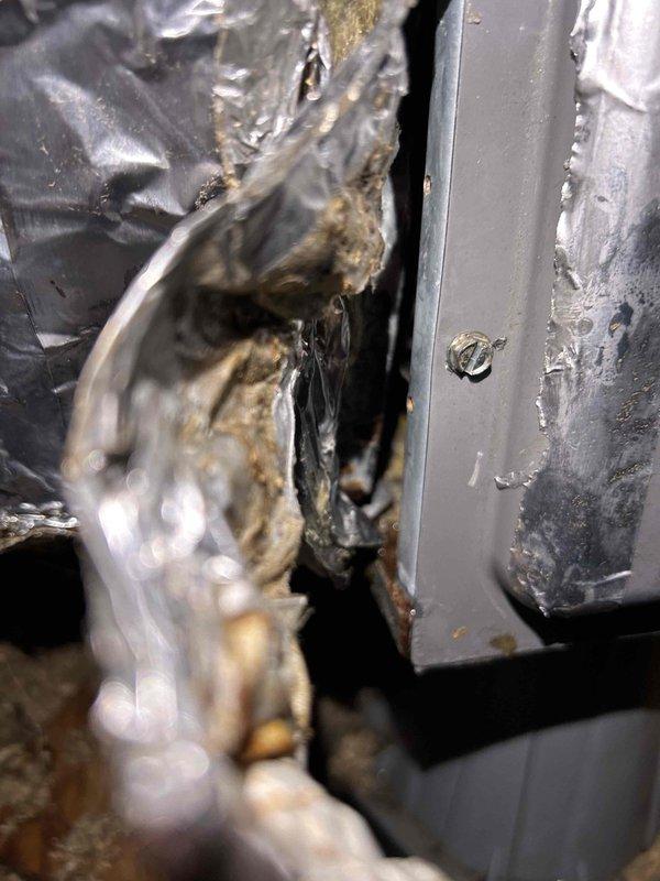 Responded to callback for HVAC system not turning on following previous water leak incident. Upon arrival, verified thermostat was set to 68°F with ambient temperature at 73°F. Confirmed no tripped breakers or frozen evaporator coil present. Inspected ductwork and system components in attic space, documenting condition of flexible duct connections and metal framework. Examined refrigerant sight glass showing amber-colored refrigerant level and condition. Performed diagnostic testing to determine if system failure was related to previous water intrusion event or separate issue requiring additional repair work.