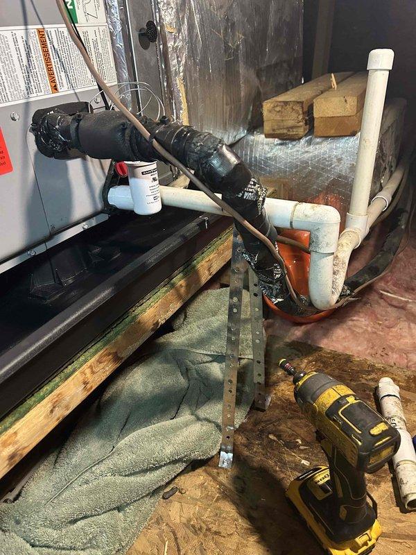 Responded to service call at vacant property to assess HVAC system after home inspector reported full drain pan. Accessed unit on top floor above washer and dryer area, inspected condensate drain system, and cleared blockage in drain line. Verified proper drainage flow, checked condensate pump operation, and confirmed system components were functioning correctly to prevent future water accumulation in drain pan.