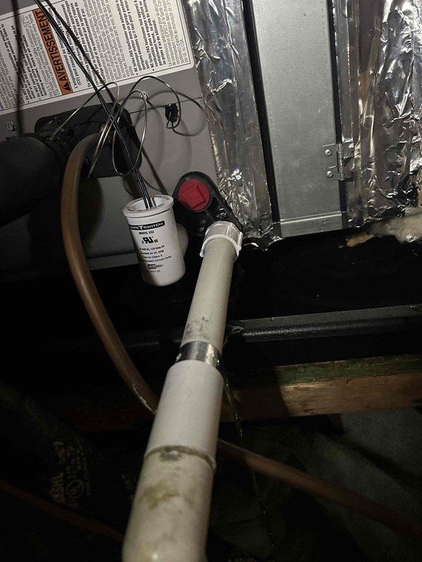 Responded to service call at vacant property to assess HVAC system after home inspector reported full drain pan. Accessed unit on top floor above washer and dryer area, inspected condensate drain system, and cleared blockage in drain line. Verified proper drainage flow, checked condensate pump operation, and confirmed system components were functioning correctly to prevent future water accumulation in drain pan.